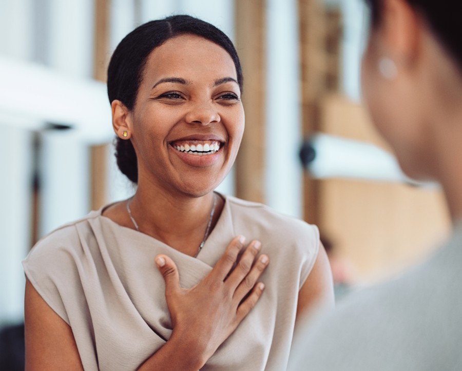 smiling women talking to colleague