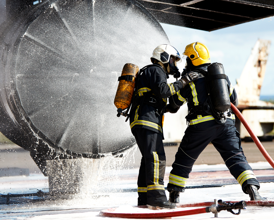 Firefighters fighing fire on jet engine