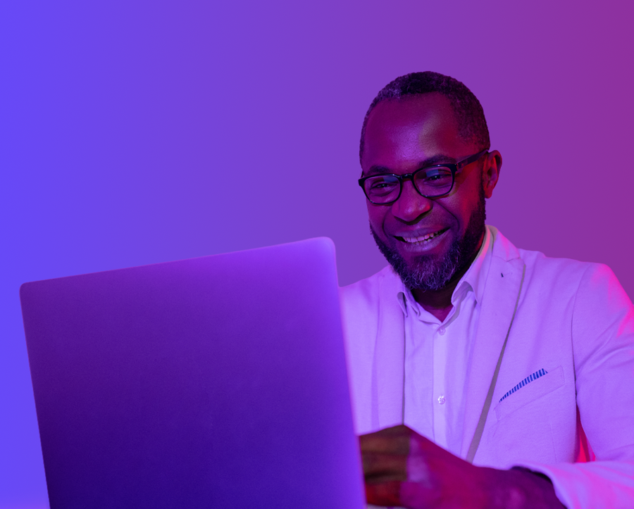 Woman at laptop with purple background