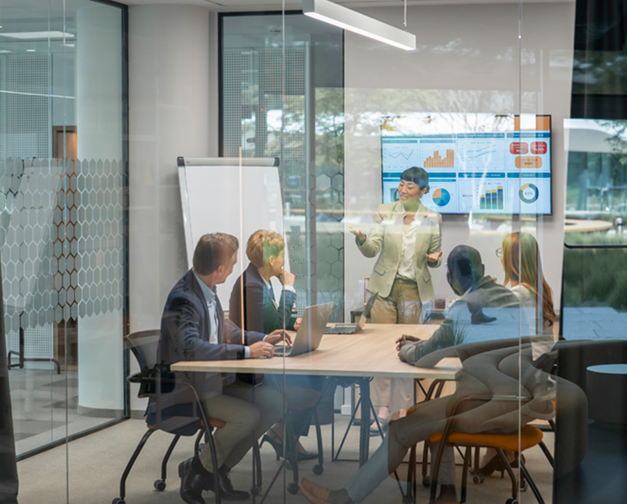 View of a meeting room with colleagues discussing