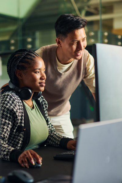 Two colleagues, man and woman, staring at computer