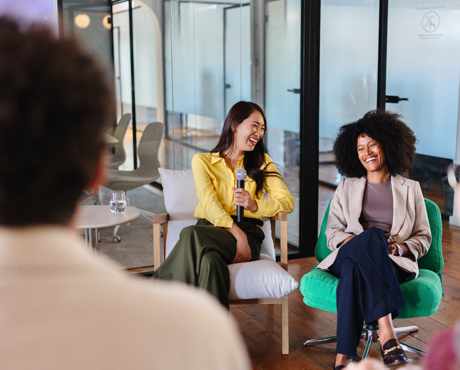 Two women sitting and talking in some type of informal talk