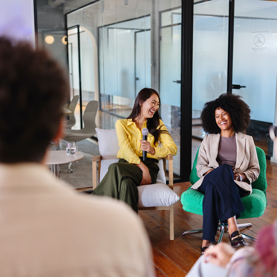 Two women sitting and talking in some type of informal talk