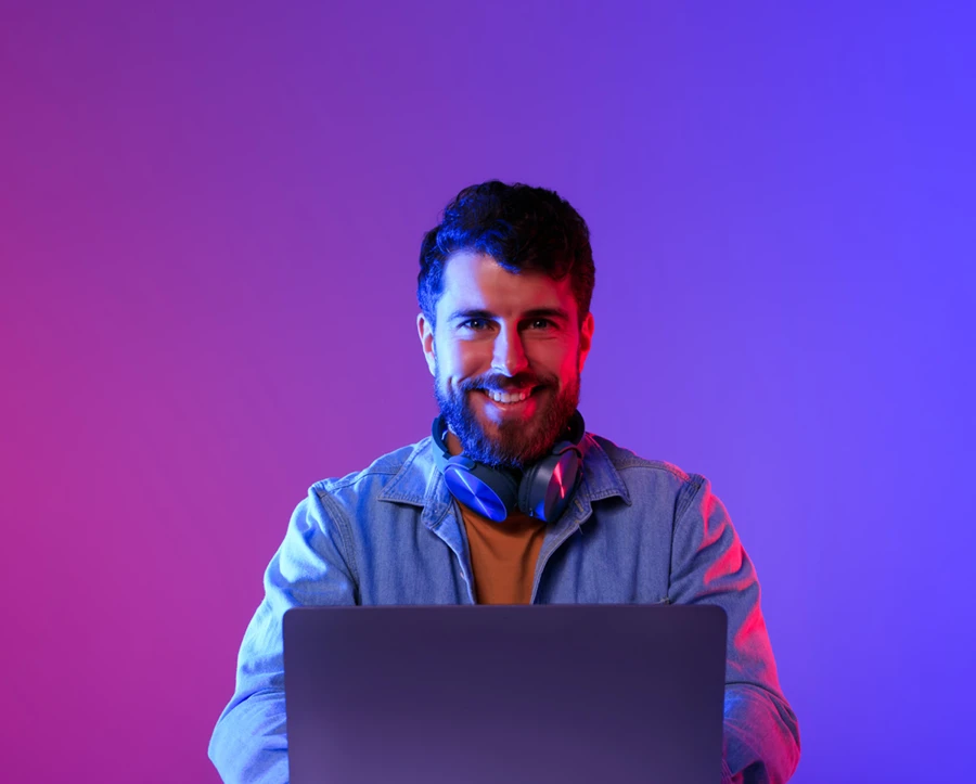 Man at laptop with purple background