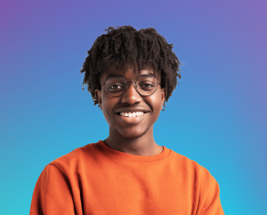 Young adult with orange jumper smiling